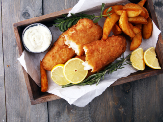 traditional British fish and chips with potato and lemon