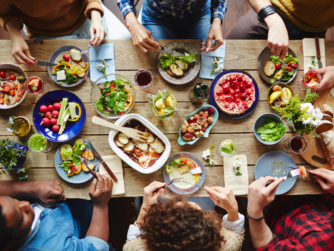 Group of young people eating dinner